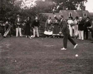 black and white still from film showing fricks' golfing