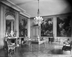 Paneled room with parquet floor, chandelier, and French furnishings