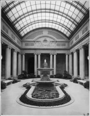 black and white photograph of frick garden court showing interior fountain surrounded by columns with skylight above