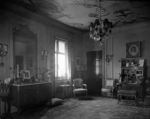 interior with dresser, chairs, chandelier, desk