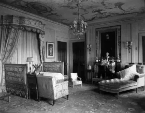 interior with bed near curtains, chairs and large lounge