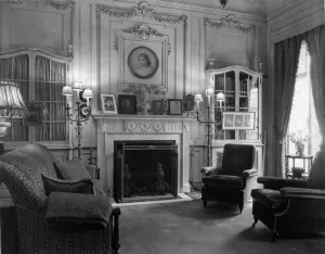 interior with sofa and two plush chairs, fireplace, lamps