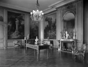 interior with wood, paintings in panels, table, chandelier, fireplace