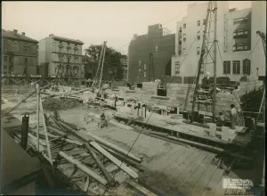 building under work amongst surrounding buildings